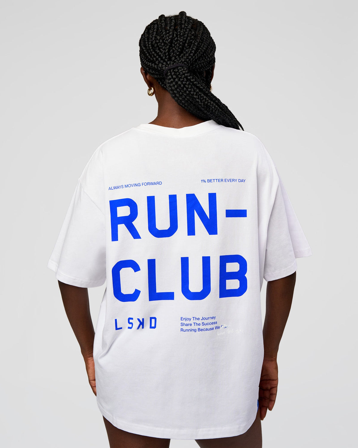 Woman wearing Go-To Run Club FLXCotton Oversized Tee - White-Electric Indigo | Model:Ellie | Size:S - view 1
