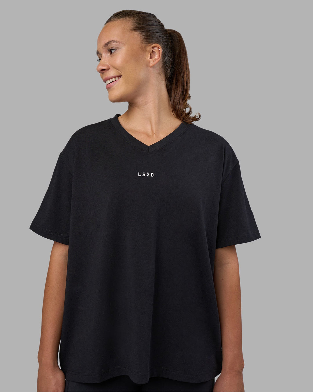 Woman wearing Go-To V-Neck FLXCotton Oversized Tee - Black-White | Model:Charlize | Size:S