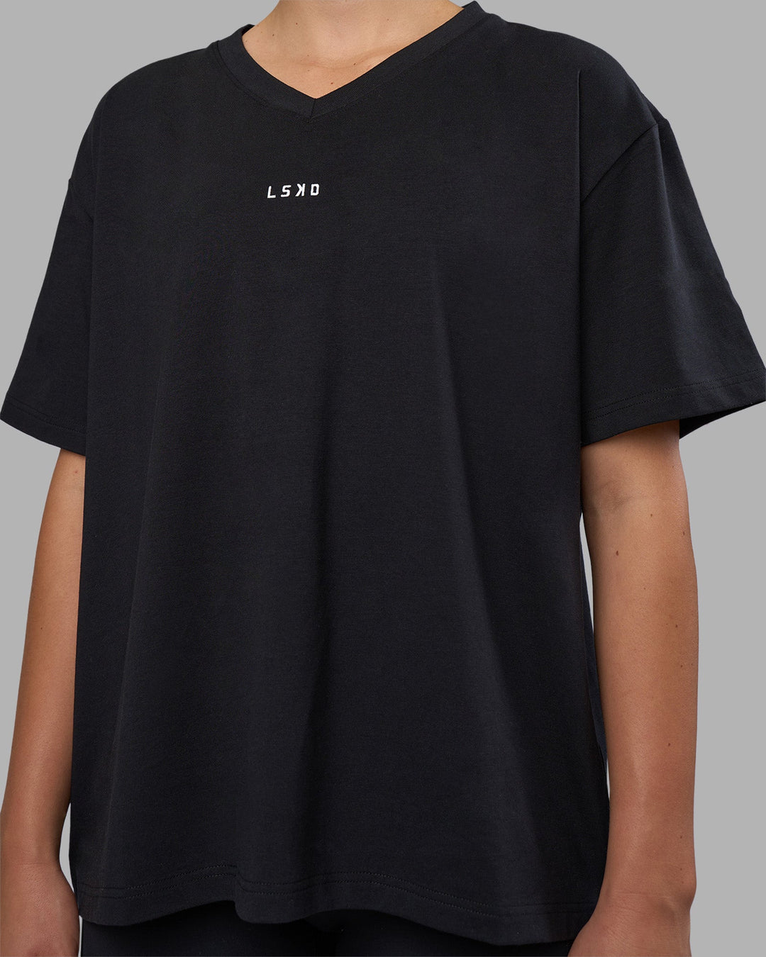 Woman wearing Go-To V-Neck FLXCotton Oversized Tee - Black-White | Model:Charlize | Size:S