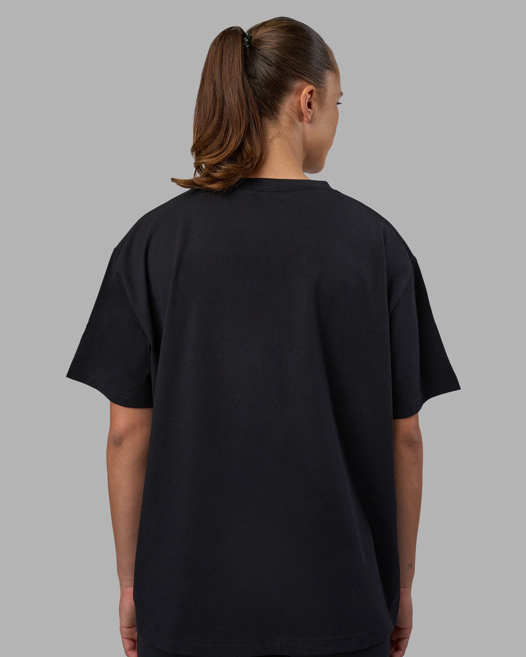 Woman wearing Go-To V-Neck FLXCotton Oversized Tee - Black-White | Model:Charlize | Size:S