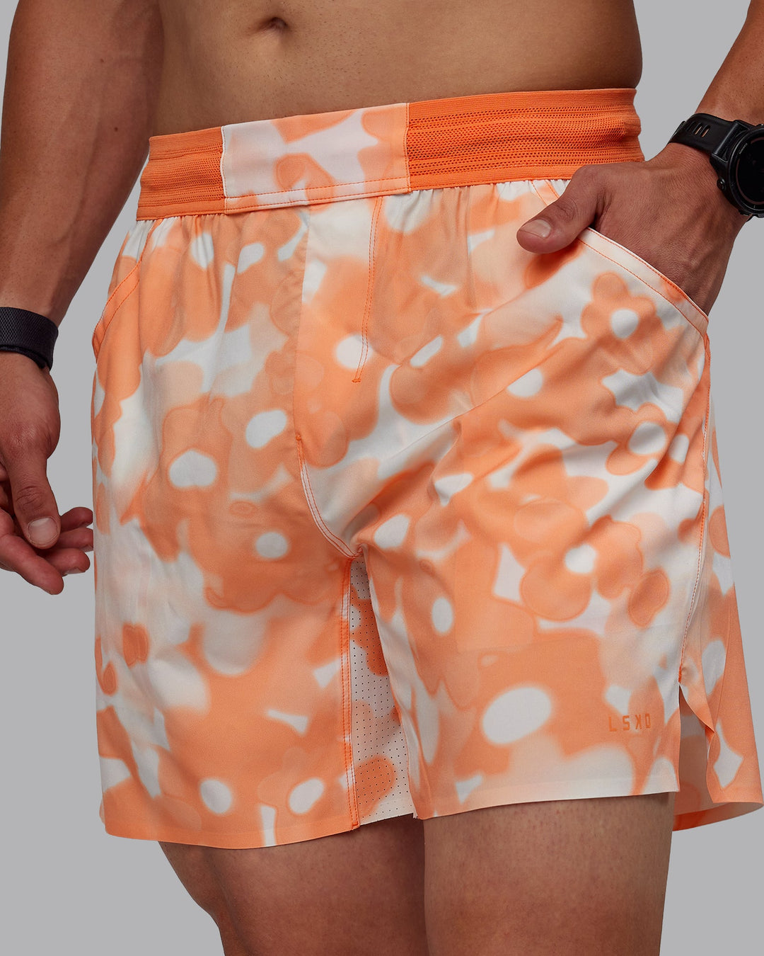 Man wearing Grand Slam 6&quot; Shorts in Wildflower Cantaloupe | Size:S