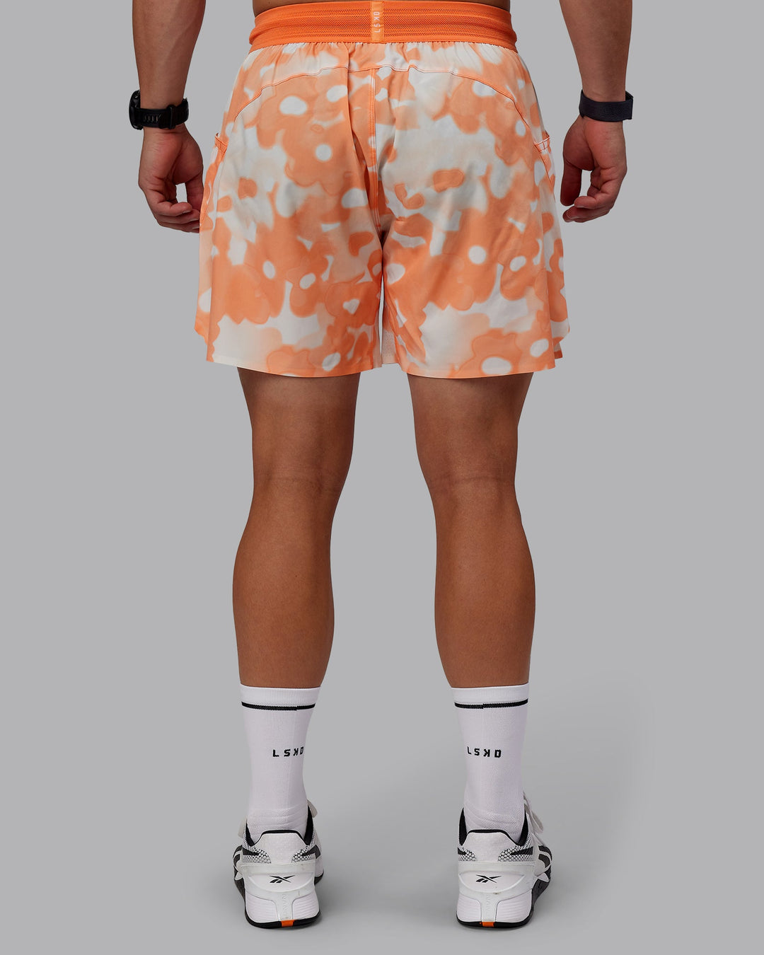 Man wearing Grand Slam 6&quot; Shorts in Wildflower Cantaloupe | Size:S