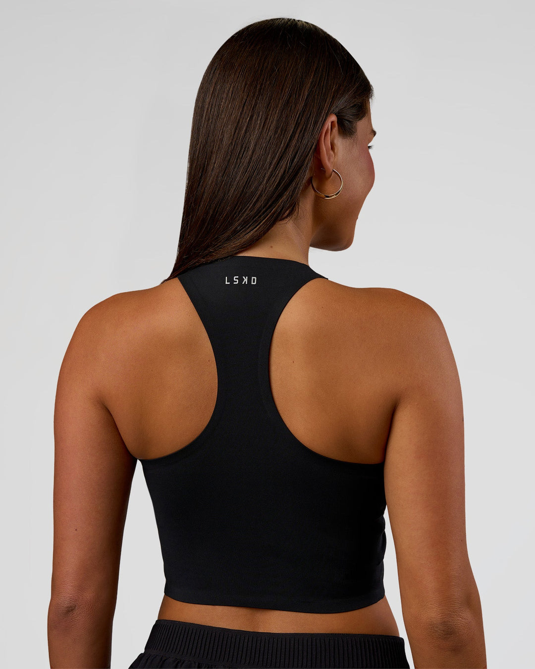 Woman wearing Hybrid Performance Crossover Tank - Black | Model:Bianca | Size:S - view 3