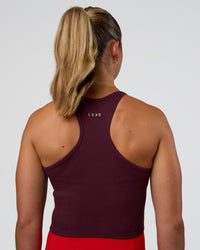 Woman wearing Ignite High Neck Tank - Cherry Lacquer | Model:Sav | Size:S | Thumbnail Index: 1
