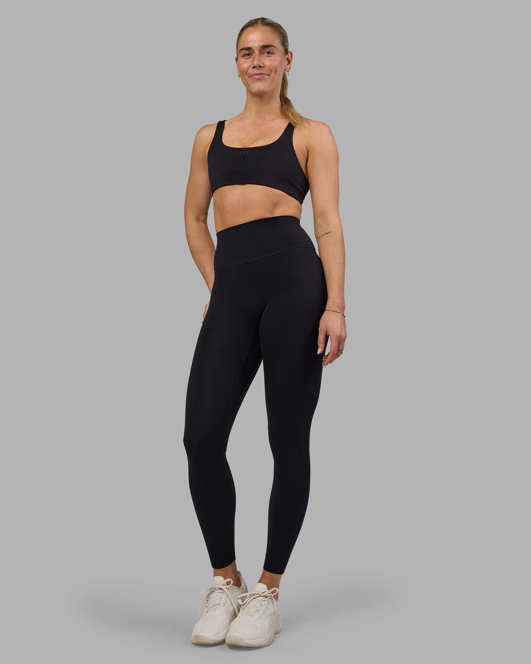Woman wearing Impulse Reversible Sports Bra - Black | Model:Hannah | Size:S