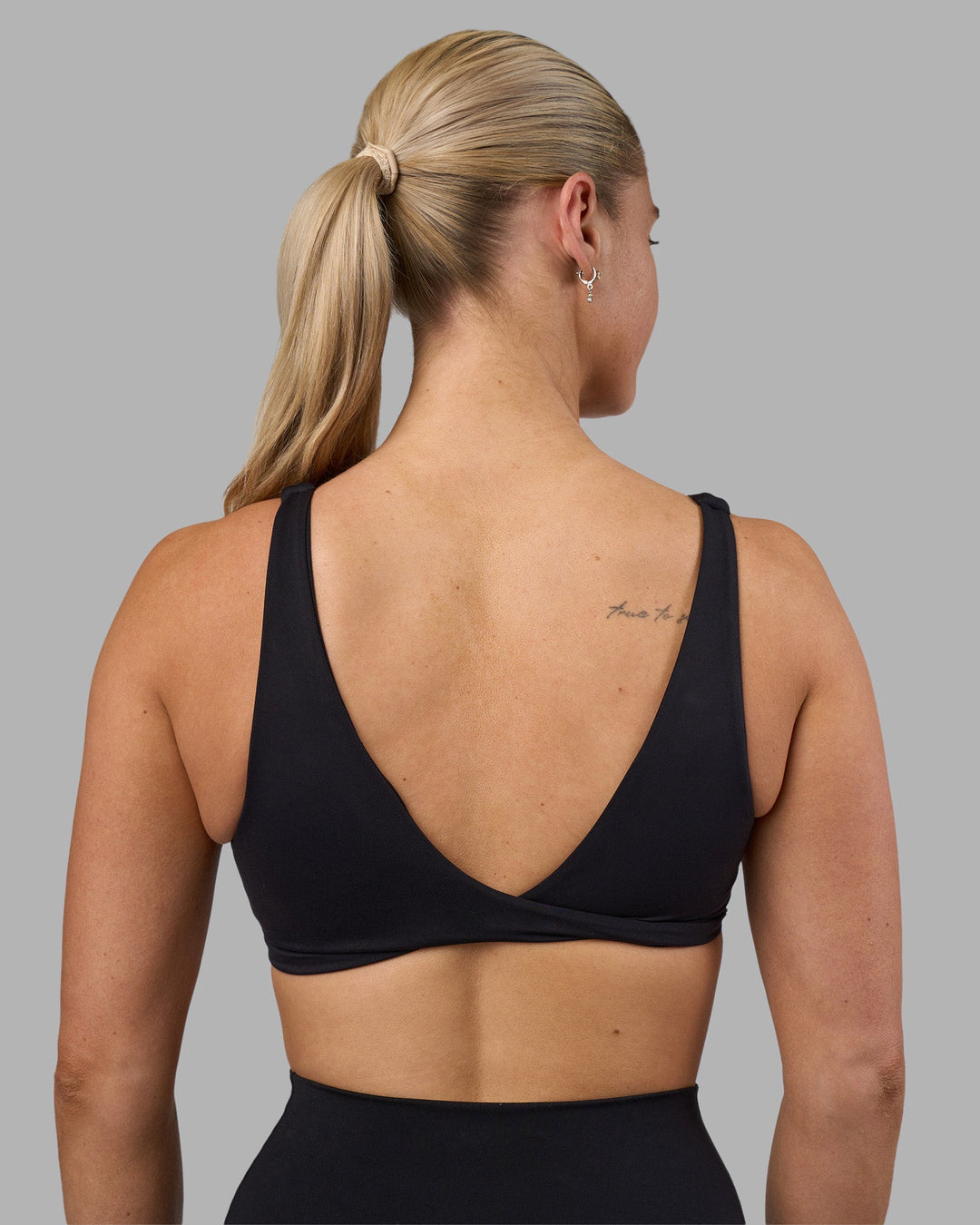 Woman wearing Impulse Reversible Sports Bra - Black | Model:Hannah | Size:S