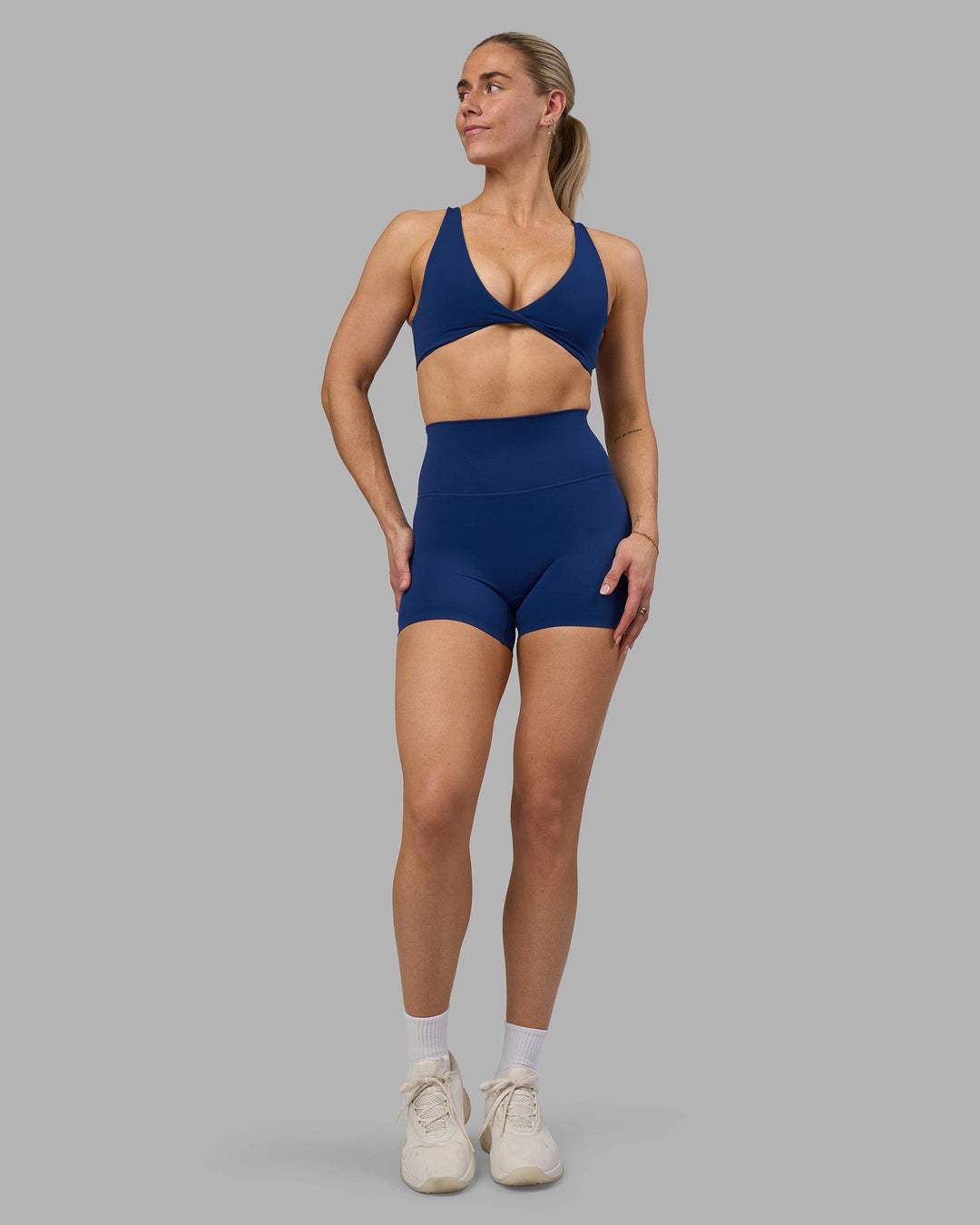 Woman wearing Impulse Reversible Sports Bra - Midnight Blue | Model:Hannah | Size:S