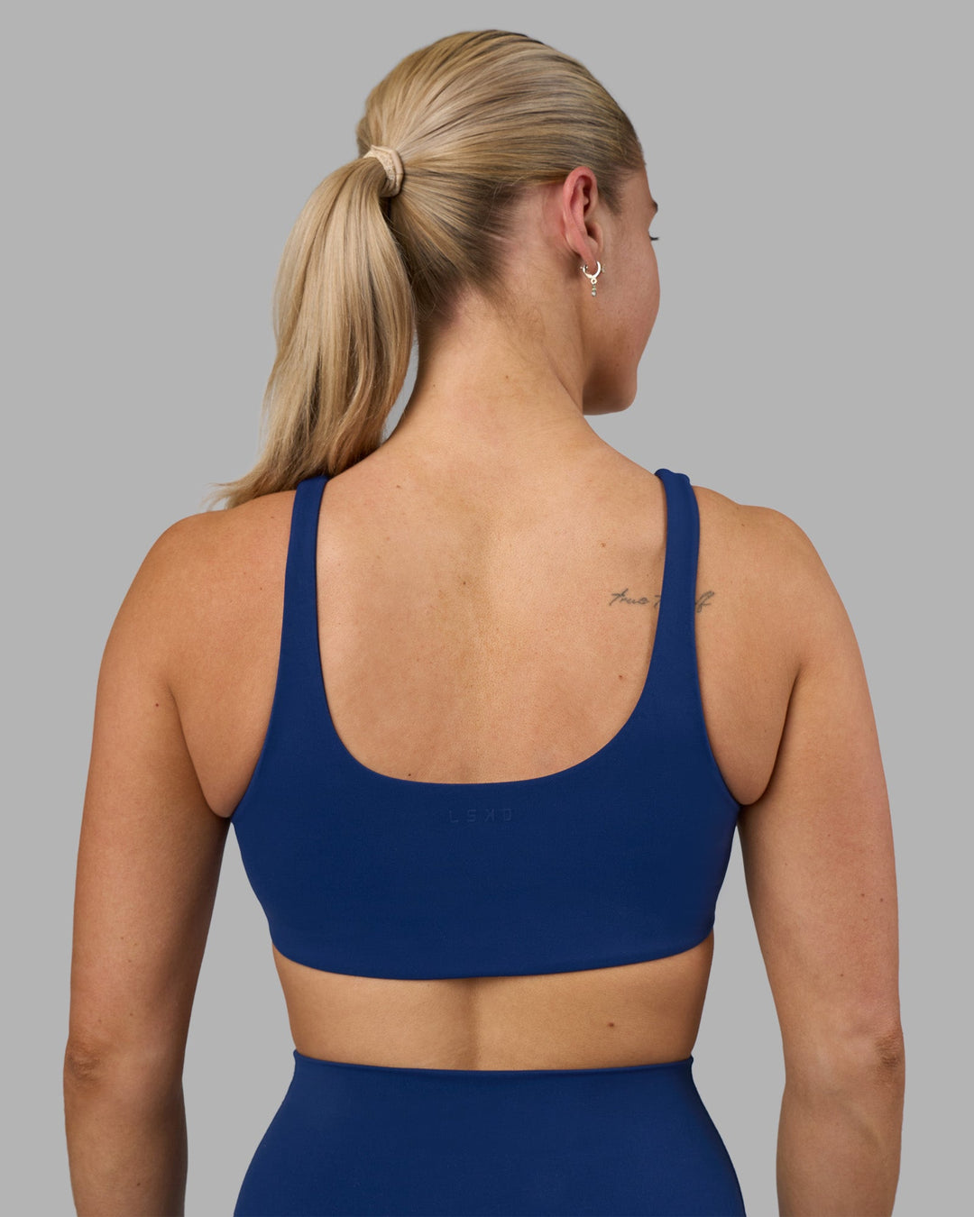 Woman wearing Impulse Reversible Sports Bra - Midnight Blue | Model:Hannah | Size:S