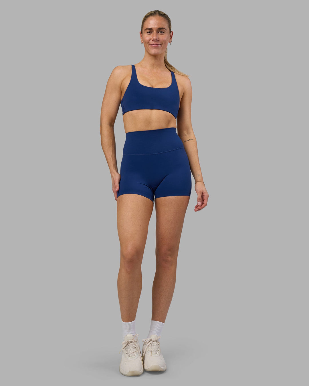 Woman wearing Impulse Reversible Sports Bra - Midnight Blue | Model:Hannah | Size:S