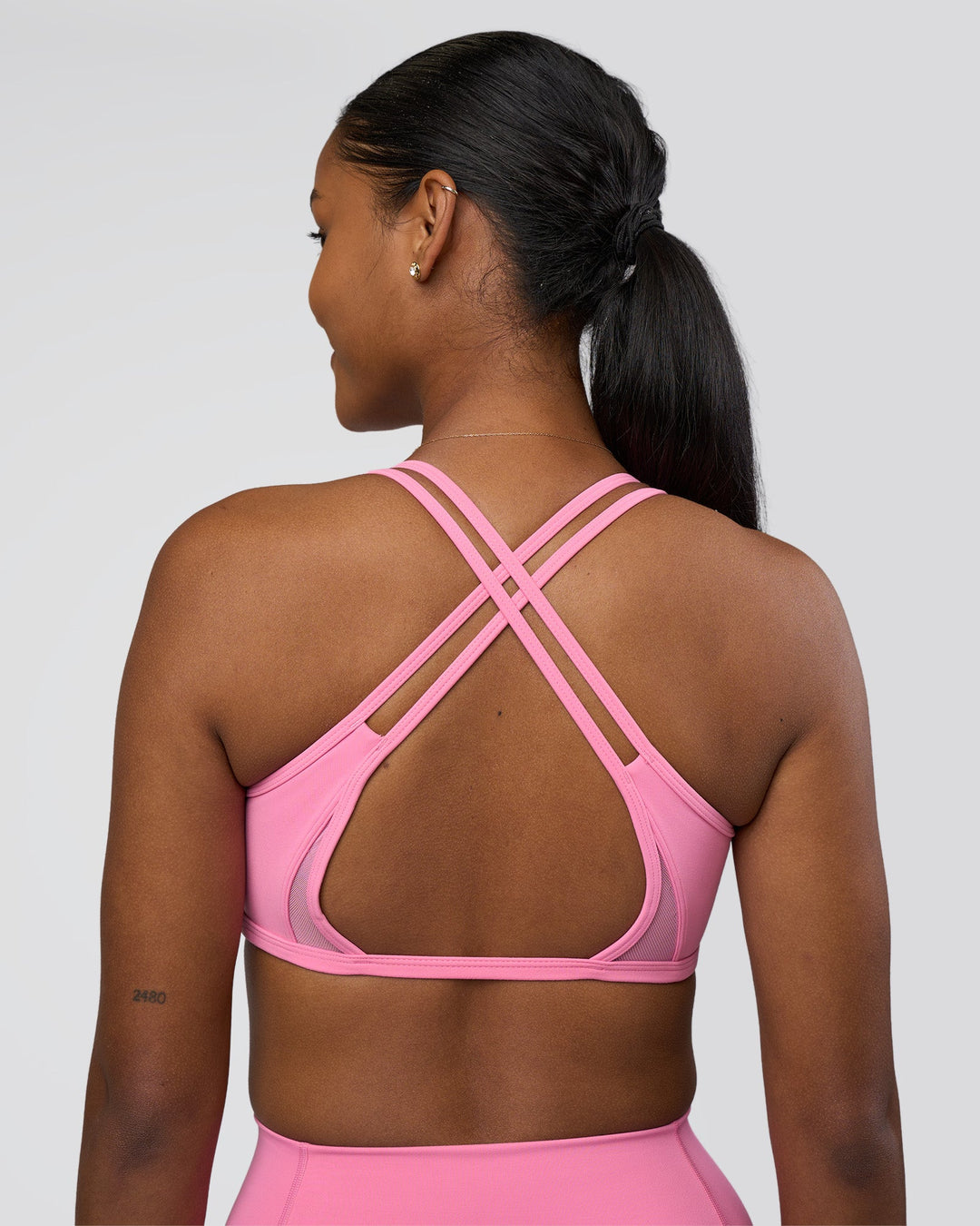 Woman wearing Interstellar Sports Bra - Candy Pink | Model:Rica | Size:S