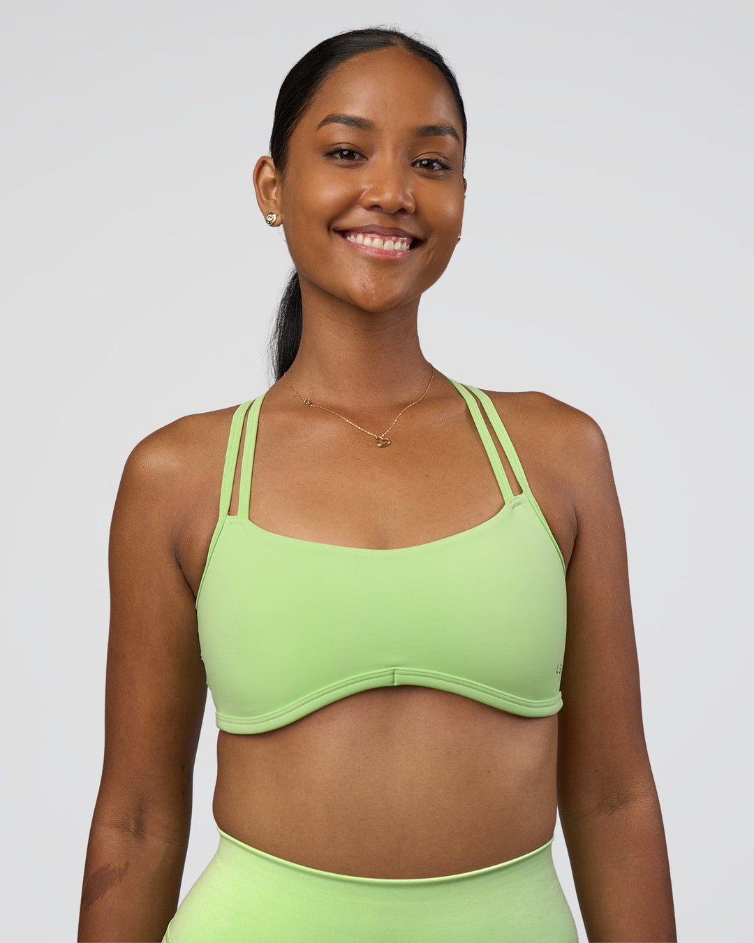 Woman wearing Interstellar Sports Bra - Solar Lime | Model:Rica | Size:S