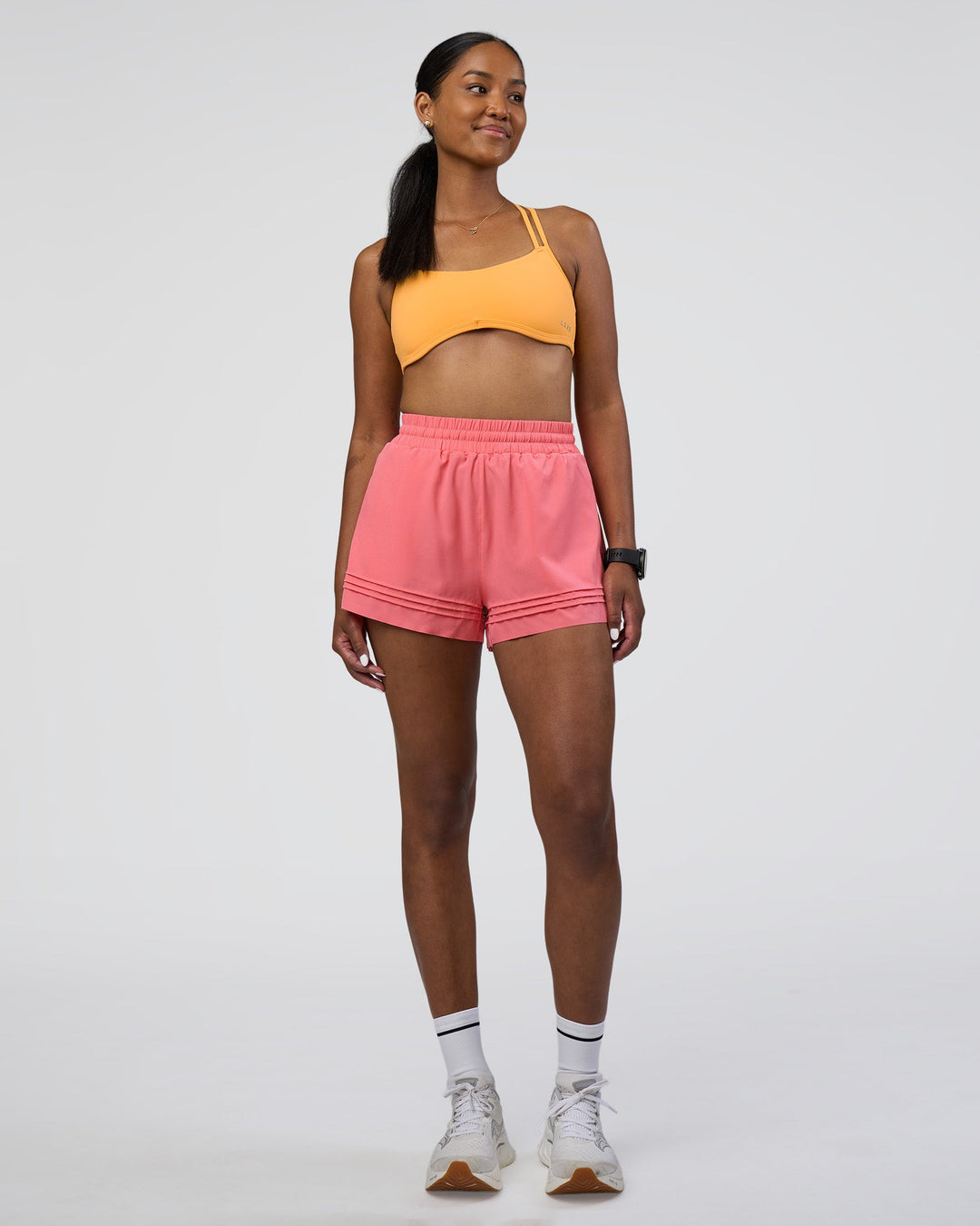 Woman wearing Interstellar Sports Bra - Warm Apricot | Model:Rica | Size:S