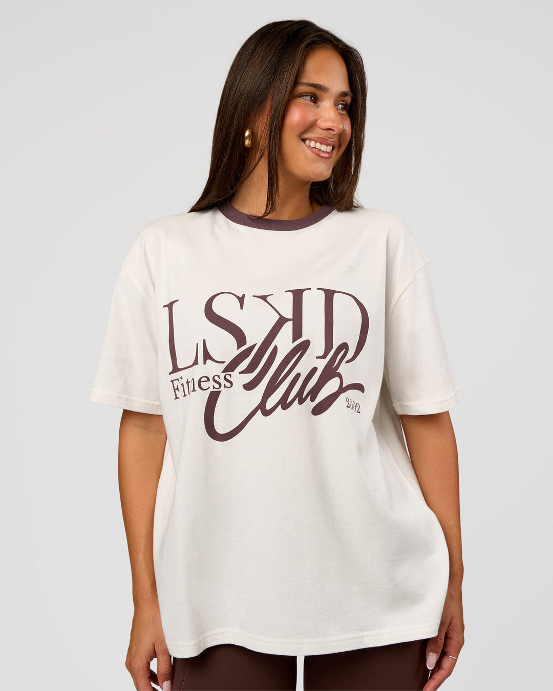 Woman wearing LSKD Fitness Club Heavyweight Oversized Tee - Off White-Cocoa Powder | Model:Bianca | Size:S