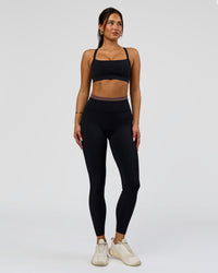 Woman wearing Liberate High-Rise Full Length Legging Pockets in Black-Cocoa Powder | Model:Bianca | Size:S | Thumbnail Index: 2