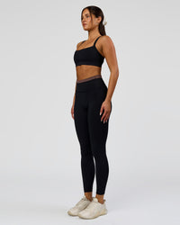 Woman wearing Liberate High-Rise Full Length Legging Pockets in Black-Cocoa Powder | Model:Bianca | Size:S | Thumbnail Index: 4