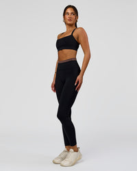 Woman wearing Liberate High-Rise Full Length Legging Pockets in Black-Cocoa Powder | Model:Bianca | Size:S | Thumbnail Index: 5
