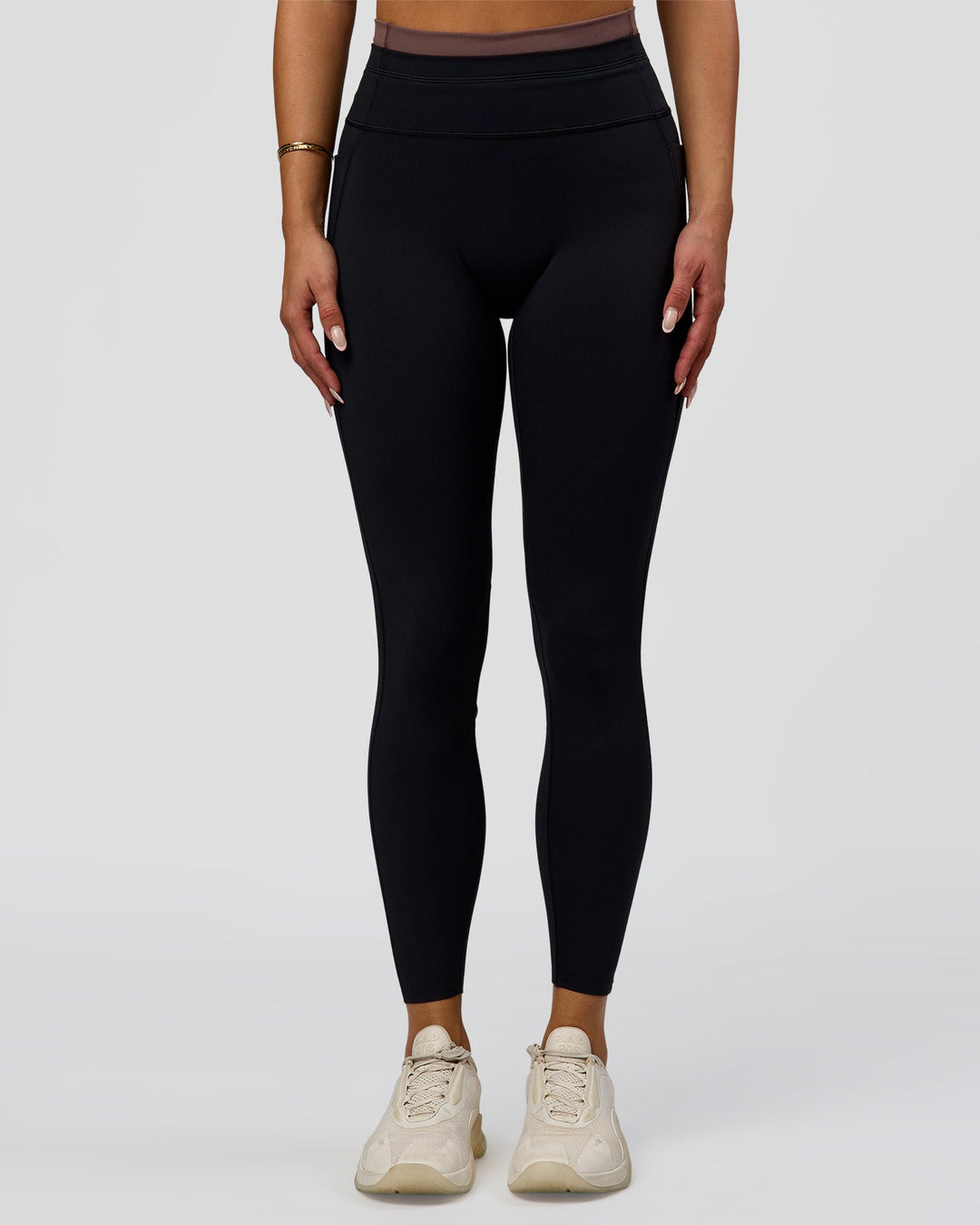 Woman wearing Liberate High-Rise Full Length Legging Pockets in Black-Cocoa Powder | Model:Bianca | Size:S - view 1