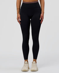 Woman wearing Liberate High-Rise Full Length Legging Pockets in Black-Cocoa Powder | Model:Bianca | Size:S | Thumbnail Index: 0