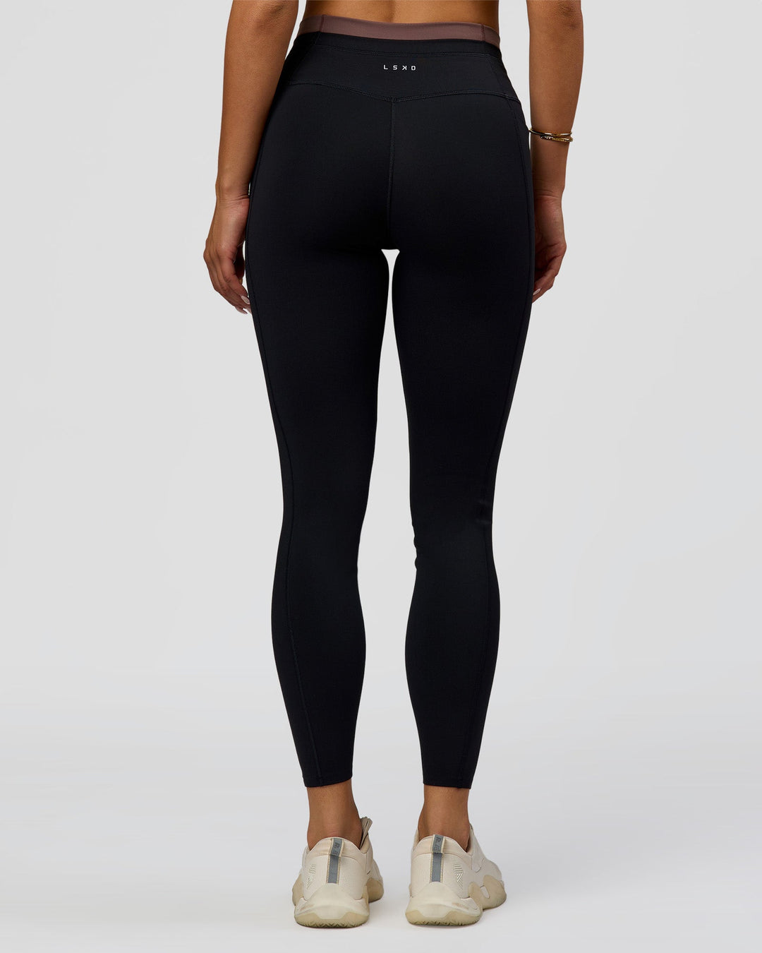 Woman wearing Liberate High-Rise Full Length Legging Pockets in Black-Cocoa Powder | Model:Bianca | Size:S - view 9