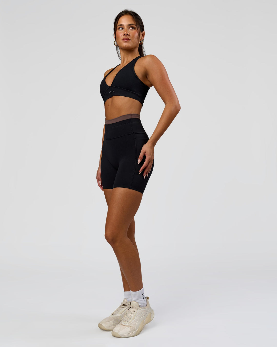 Woman wearing Liberate High-Rise 6" Short Pockets in Black-Cocoa Powder | Model:Bianca | Size:S - view 4