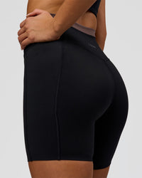 Woman wearing Liberate High-Rise 6" Short Pockets in Black-Cocoa Powder | Model:Bianca | Size:S | Thumbnail Index: 1