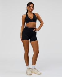 Woman wearing Liberate High-Rise 4" Short Pockets in Black-Cocoa Powder | Model:Bianca | Size:S | Thumbnail Index: 2
