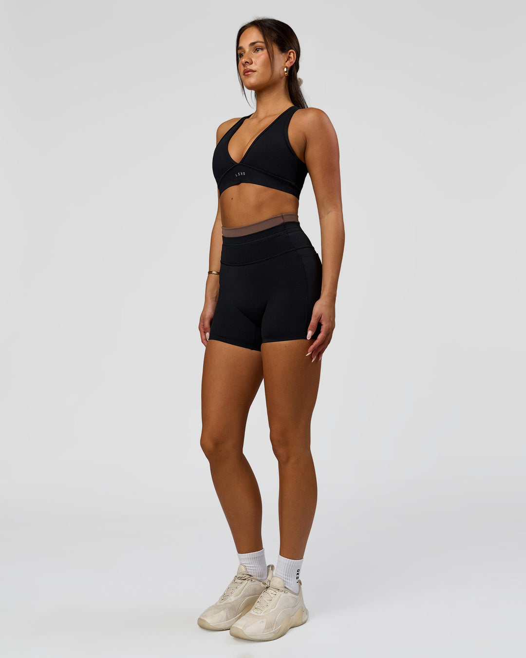 Woman wearing Liberate High-Rise 4" Short Pockets in Black-Cocoa Powder | Model:Bianca | Size:S - view 5