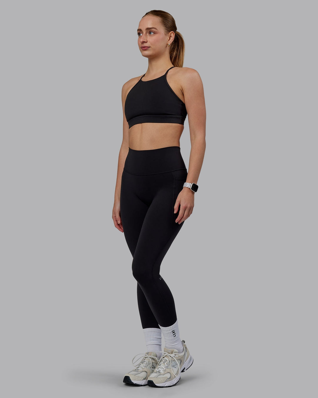 Woman wearing Lift High Neck Sports Bra - Black