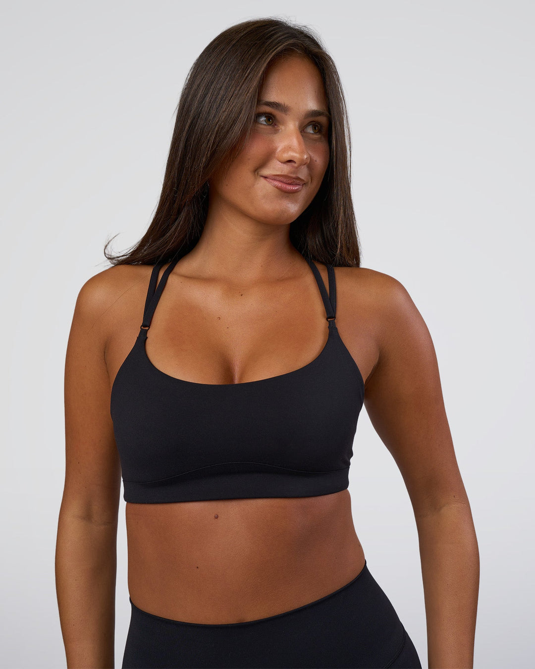 Woman wearing Luminate Sports Bra - Black | Model:Bianaca | Size:S