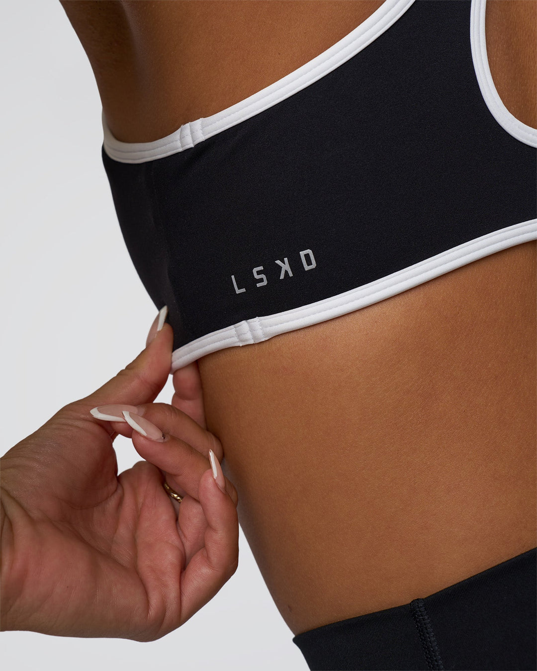 Woman wearing Luminous Sports Bra - Black-White | Model:Bianca | Size:S