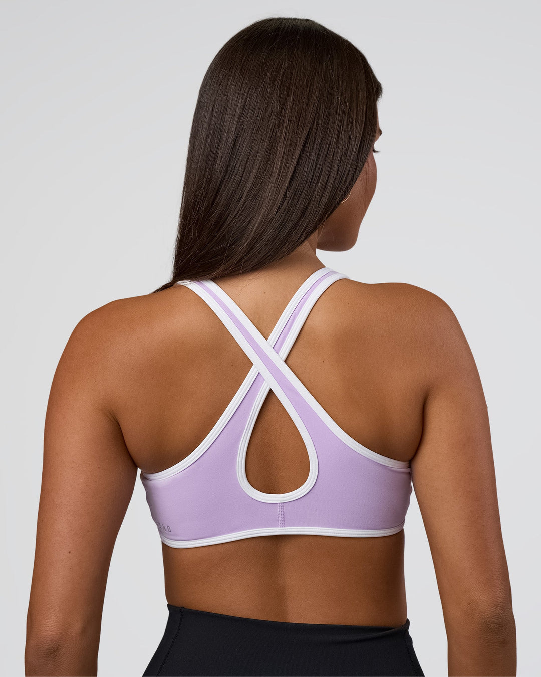 Woman wearing Luminous Sports Bra - Pale Lilac-White | Model:Bianca | Size:S