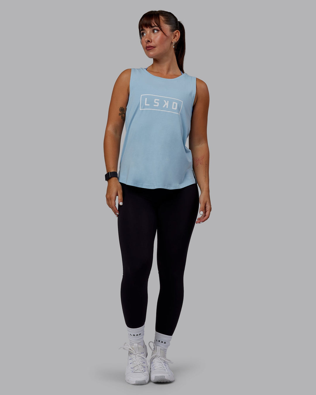 Woman wearing Luna FLXCotton Longline Tank - Glacial Blue-White