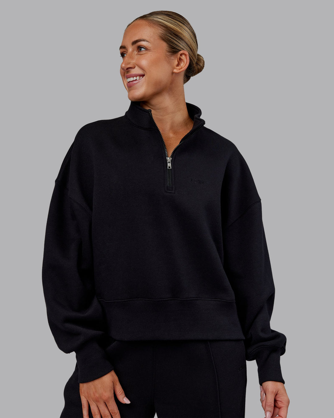 Woman wearing MVP 1/2 Zip Oversized Sweater - Black | Model:Paris | Size:S