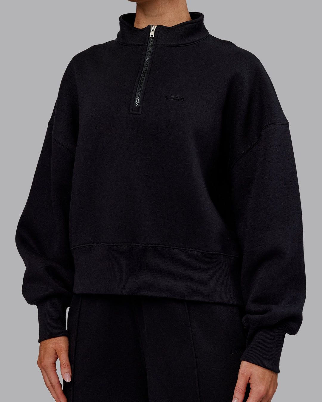 Woman wearing MVP 1/2 Zip Oversized Sweater - Black | Model:Paris | Size:S