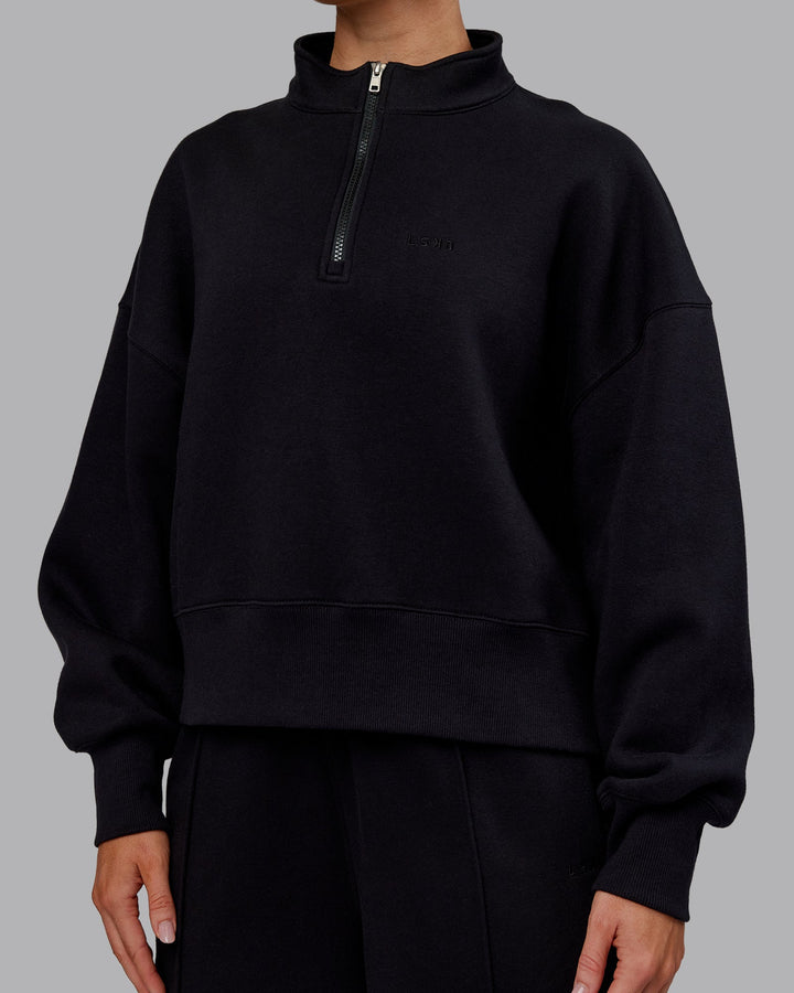 Woman wearing MVP 1/2 Zip Oversized Sweater - Black | Model:Paris | Size:S
