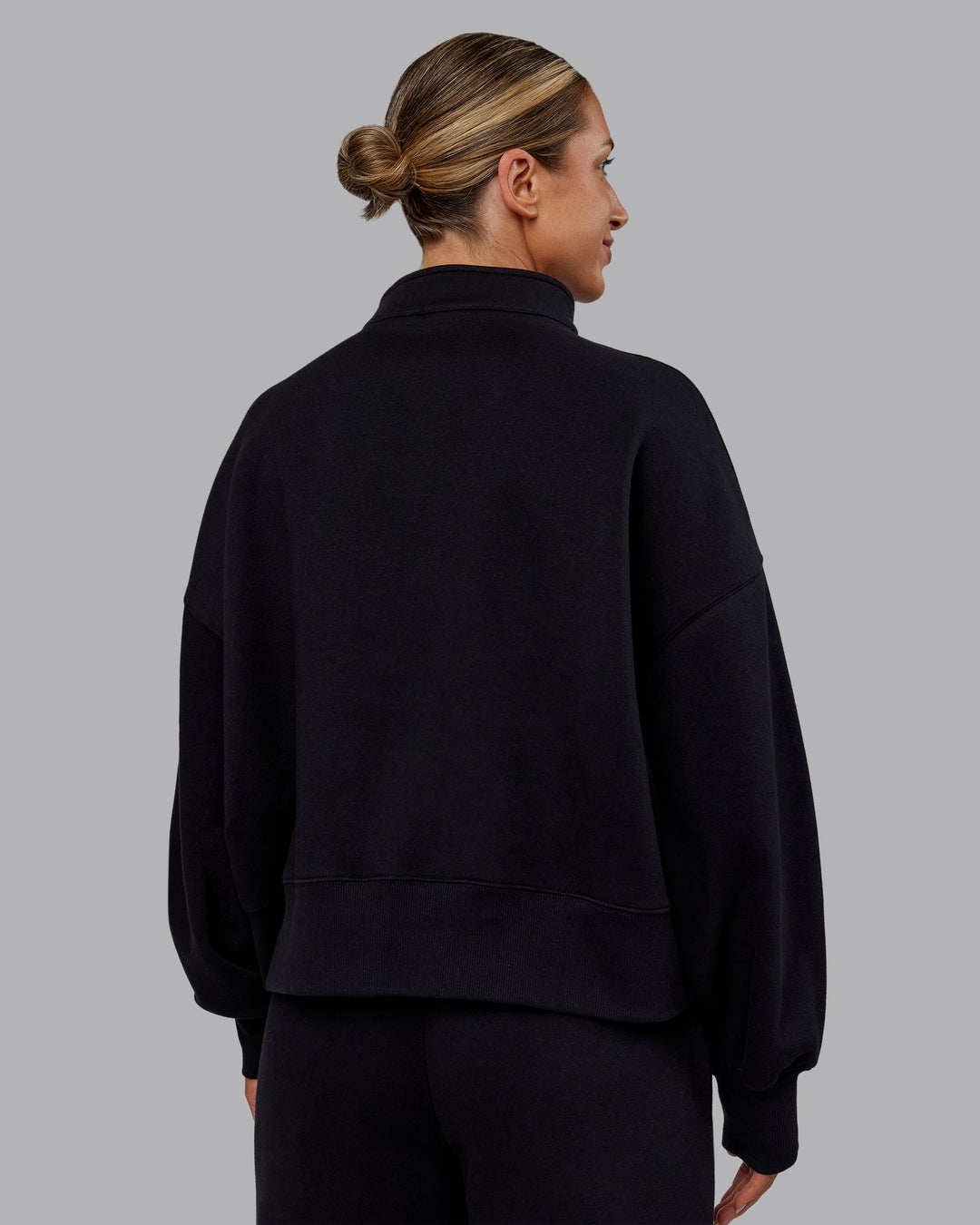 Woman wearing MVP 1/2 Zip Oversized Sweater - Black | Model:Paris | Size:S