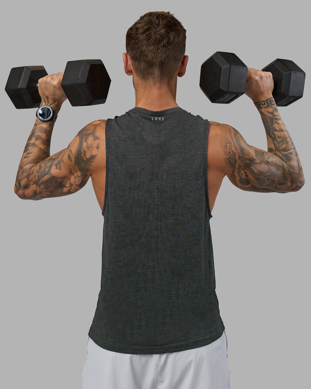 Man wearing AeroFLX+ Seamless Muscle Tank - Black Camo-Graphite | Model:Tommy | Size:S