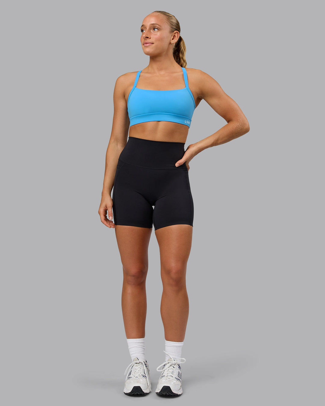 Woman wearing Momentum Sports Bra in Azure Blue | Size:S