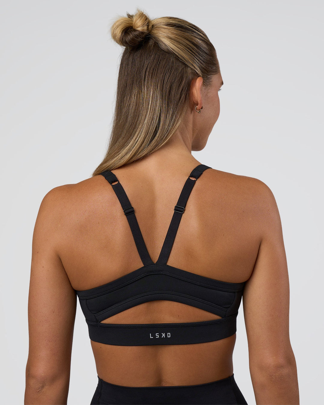 Woman wearing Momentum Sports Bra - Black | Model:Amity | Size:S