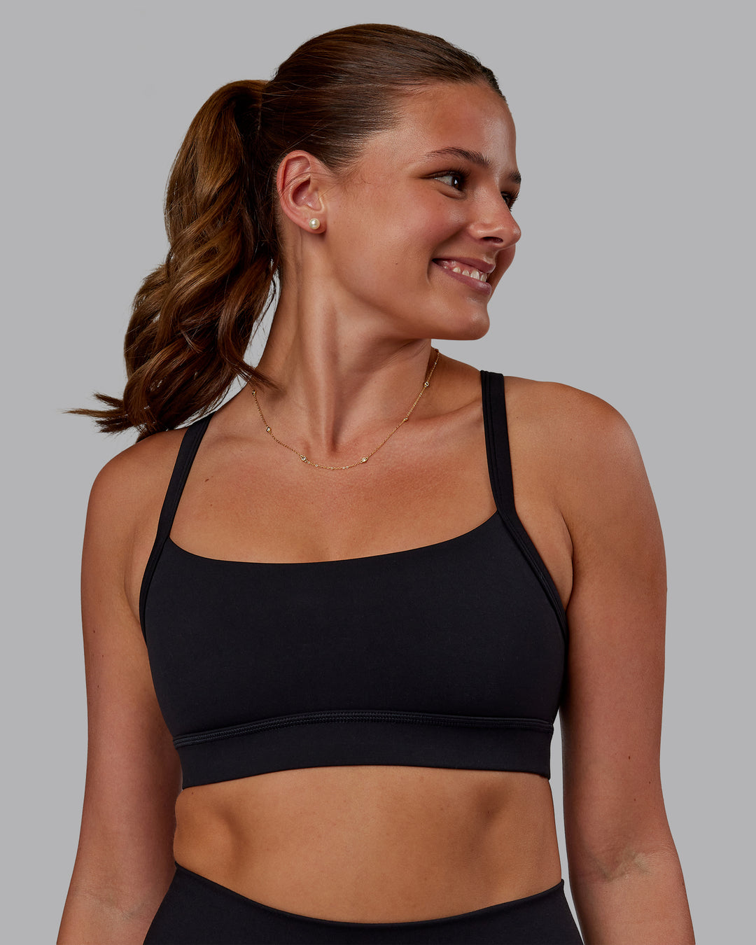 Woman wearing Momentum Sports Bra - Black | Model:Phoebe | Size:S