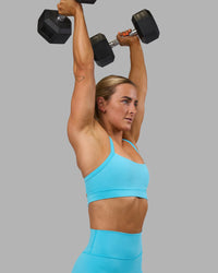 Woman wearing Momentum Sports Bra - Blue Atoll | Model:Georgia | Size:S