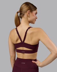 Woman wearing Momentum Sports Bra - Cherry Lacquer | Model:Emilie | Size:S