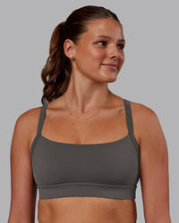 Woman wearing Momentum Sports Bra - Dark Storm | Model:Phoebe | Size:S