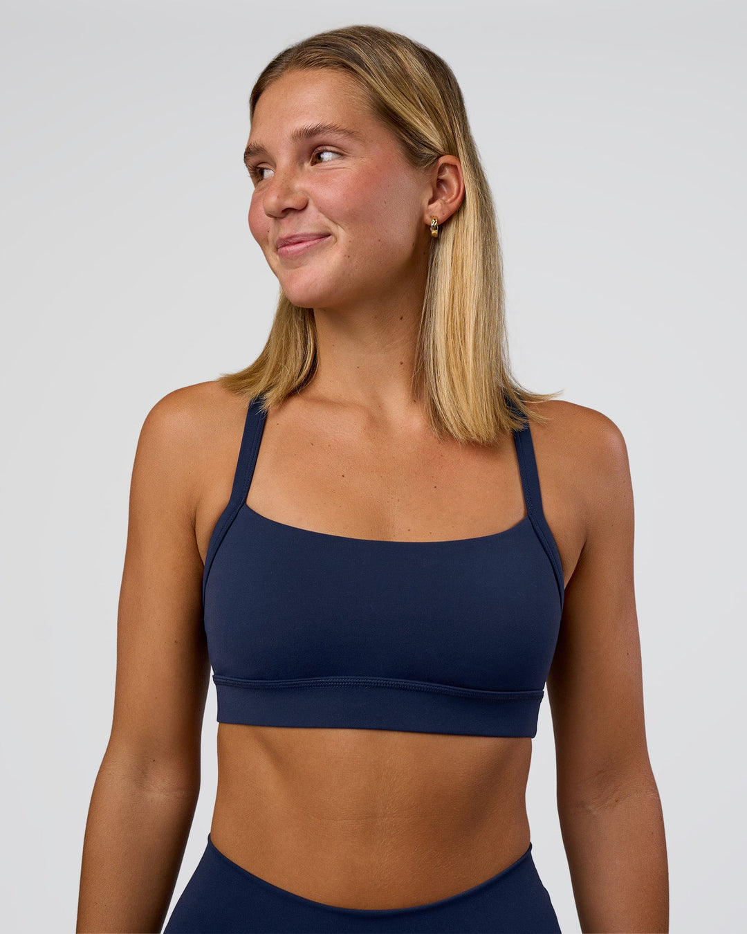 Woman wearing Momentum Sports Bra - Future Navy | Model:Amity | Size:S - view 1