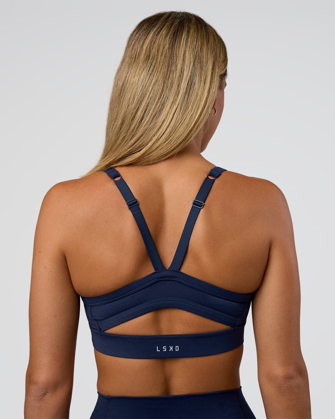 Woman wearing Momentum Sports Bra - Future Navy | Model:Amity | Size:S
