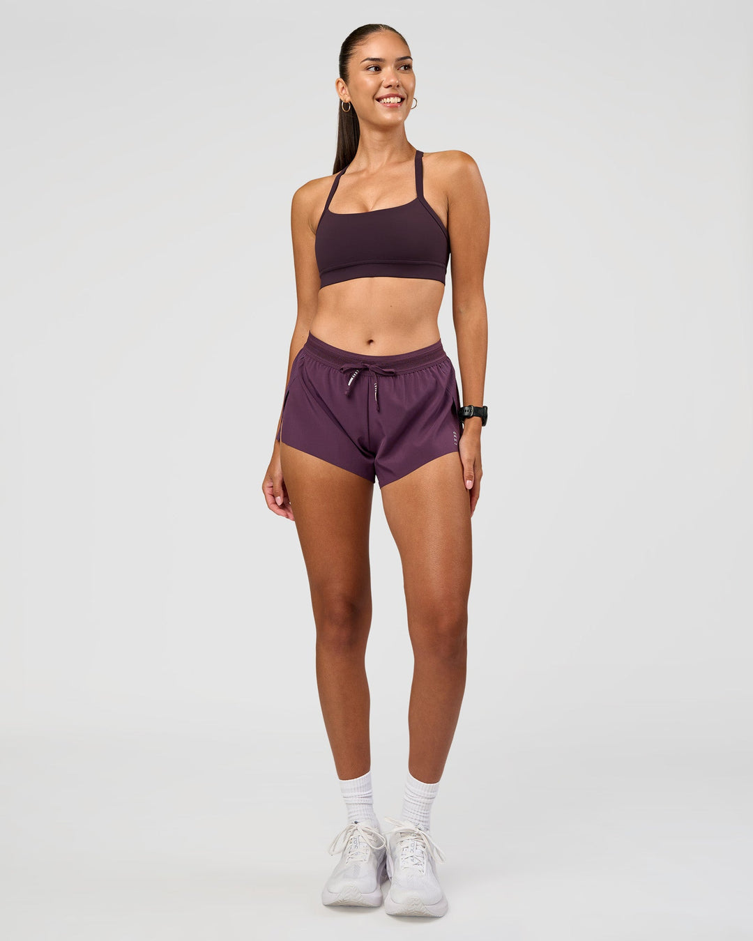 Woman wearing Momentum Sports Bra - Midnight Plum | Model:Rhiley | Size:S