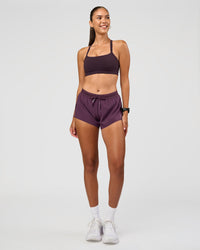 Woman wearing Momentum Sports Bra - Midnight Plum | Model:Rhiley | Size:S