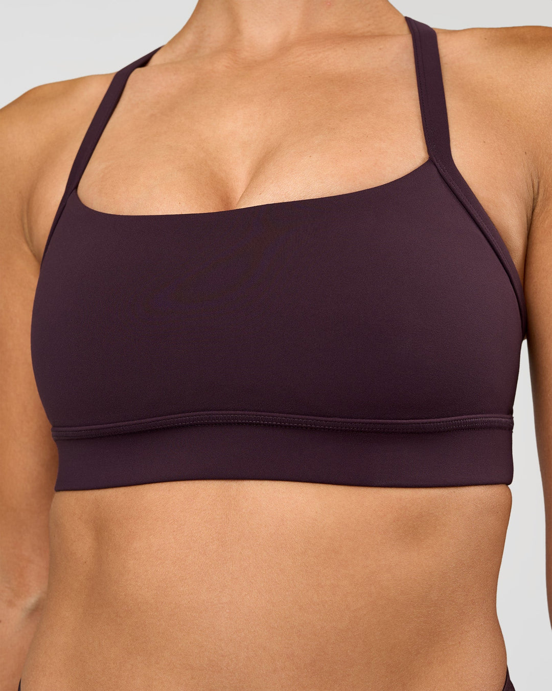 Woman wearing Momentum Sports Bra - Midnight Plum | Model:Rhiley | Size:S