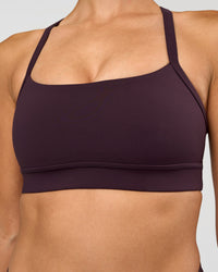 Woman wearing Momentum Sports Bra - Midnight Plum | Model:Rhiley | Size:S