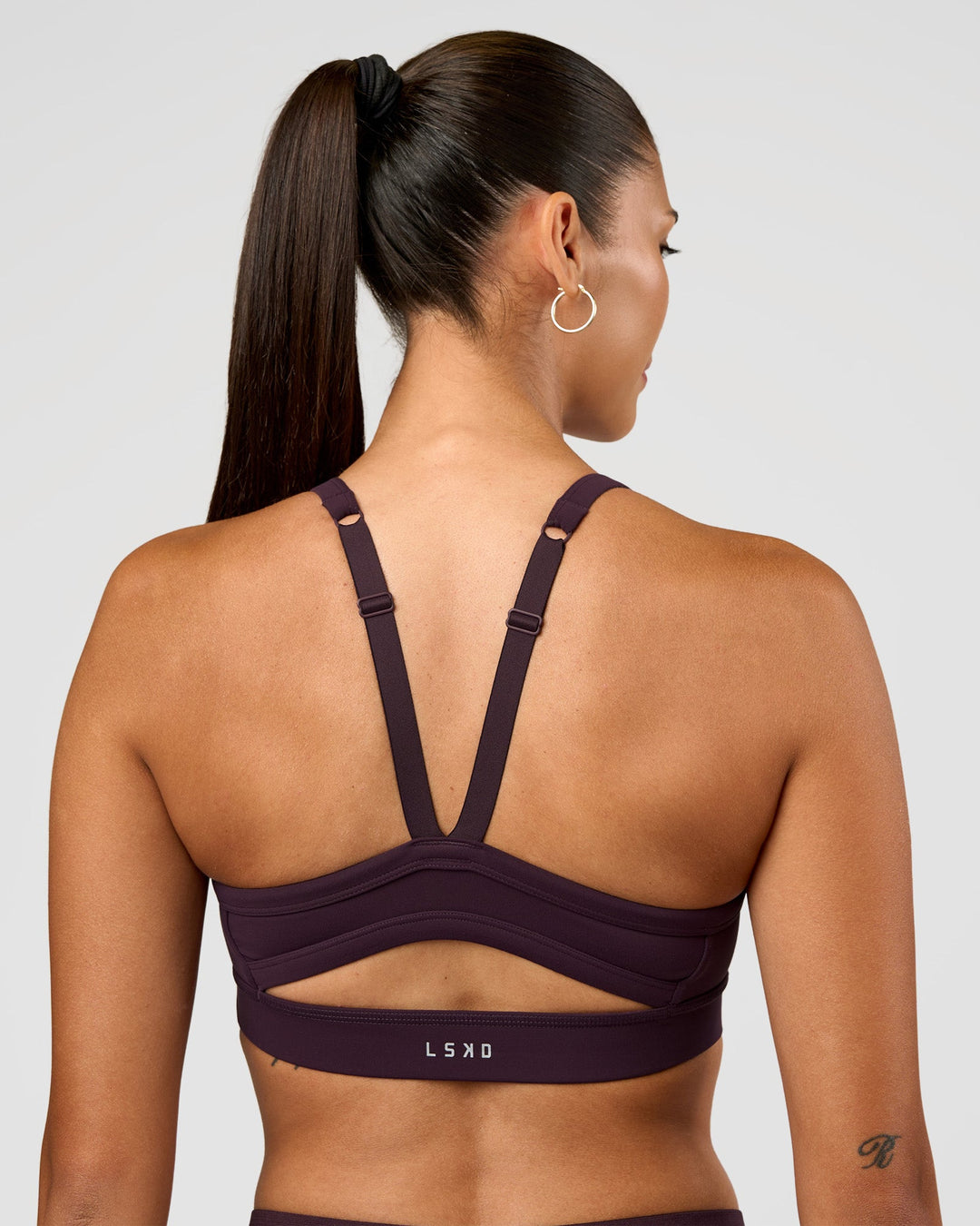 Woman wearing Momentum Sports Bra - Midnight Plum | Model:Rhiley | Size:S